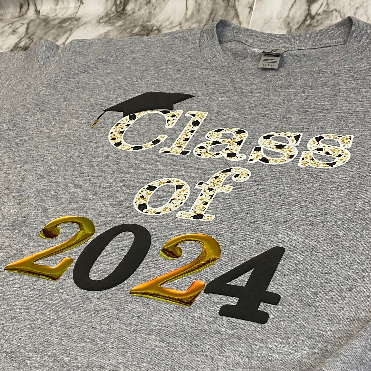 Side View of Sublimated Class of 2024 with Puff Black, Glittery White and Holographic Gold Vinyl T-Shirt
