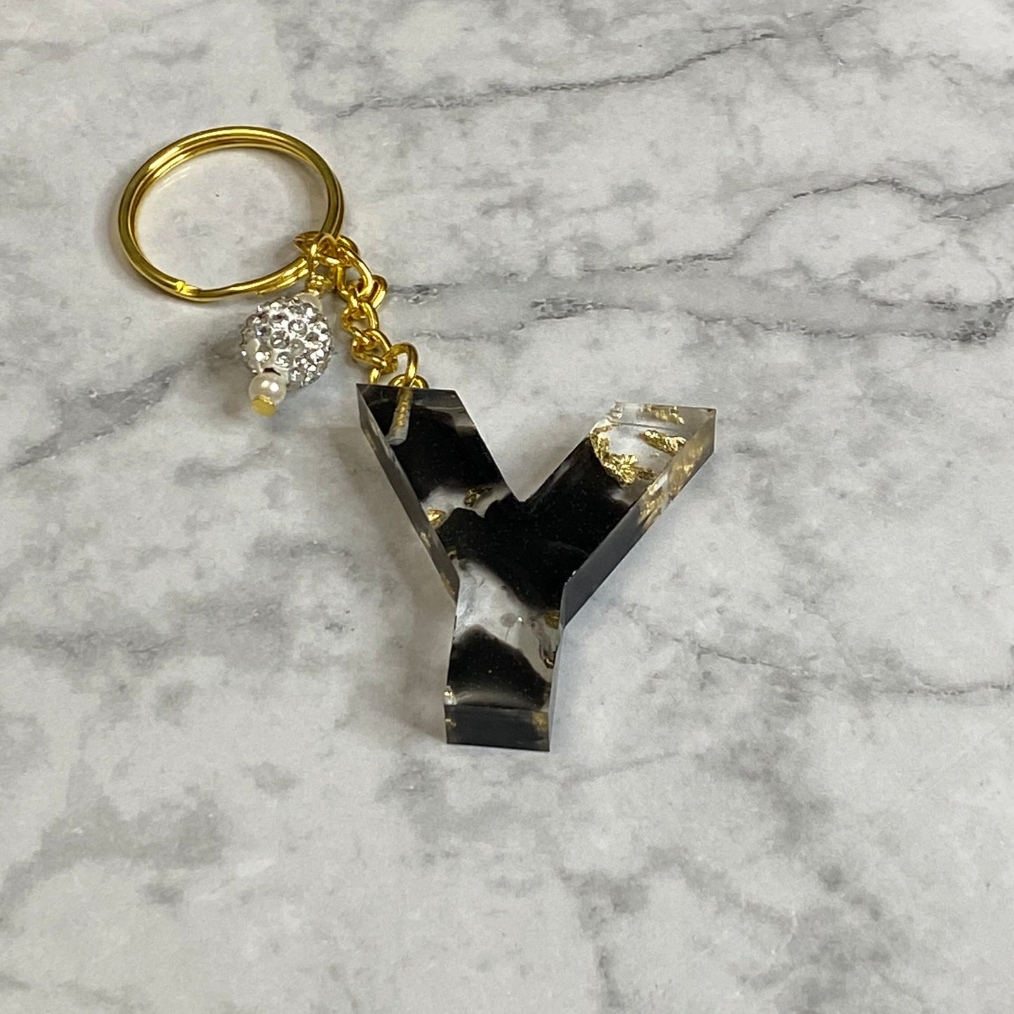 Letter Y of The Clear Resin Alphabet Letter Keychain with Gold Flake and Black Accents