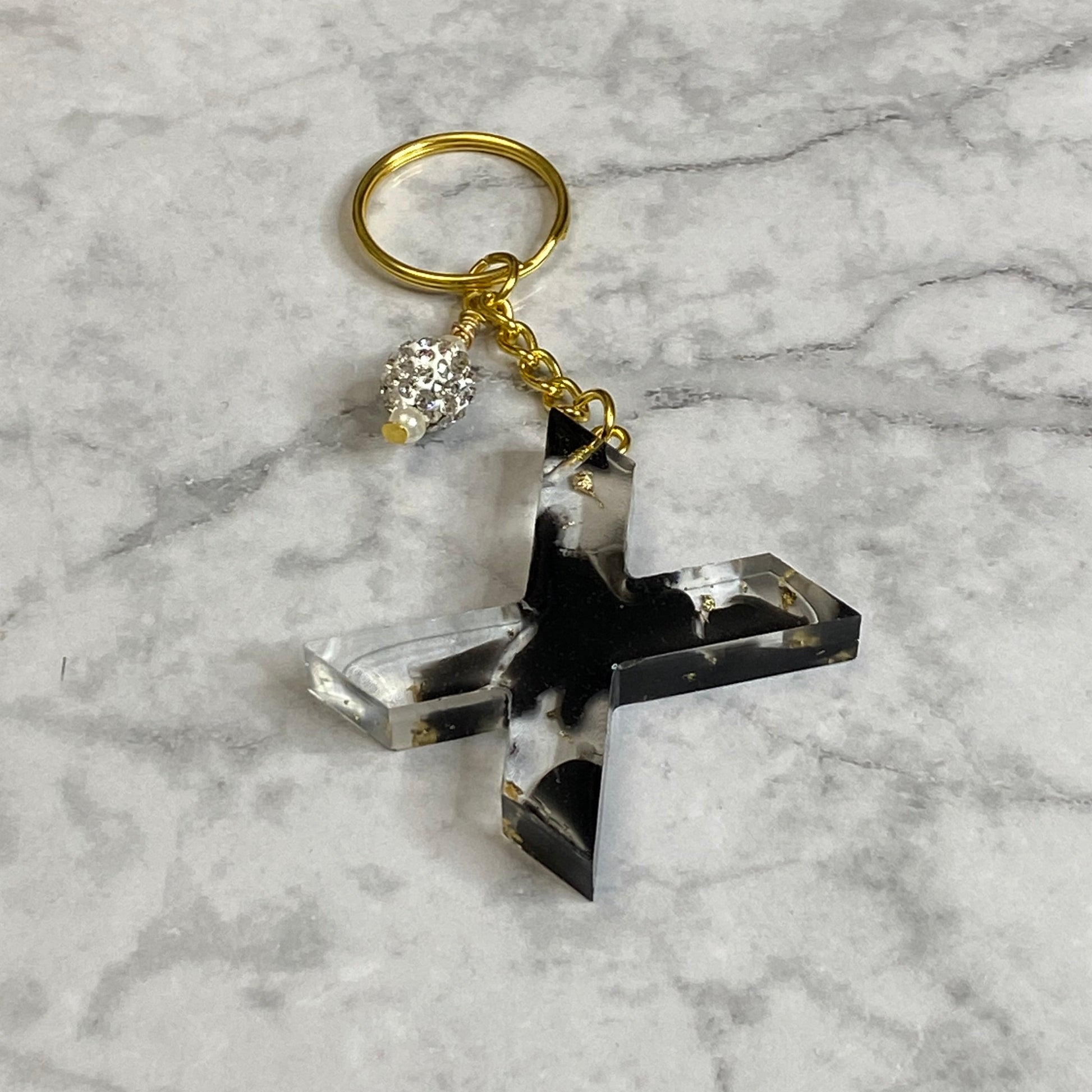 Letter X of The Clear Resin Alphabet Letter Keychain with Gold Flake and Black Accents