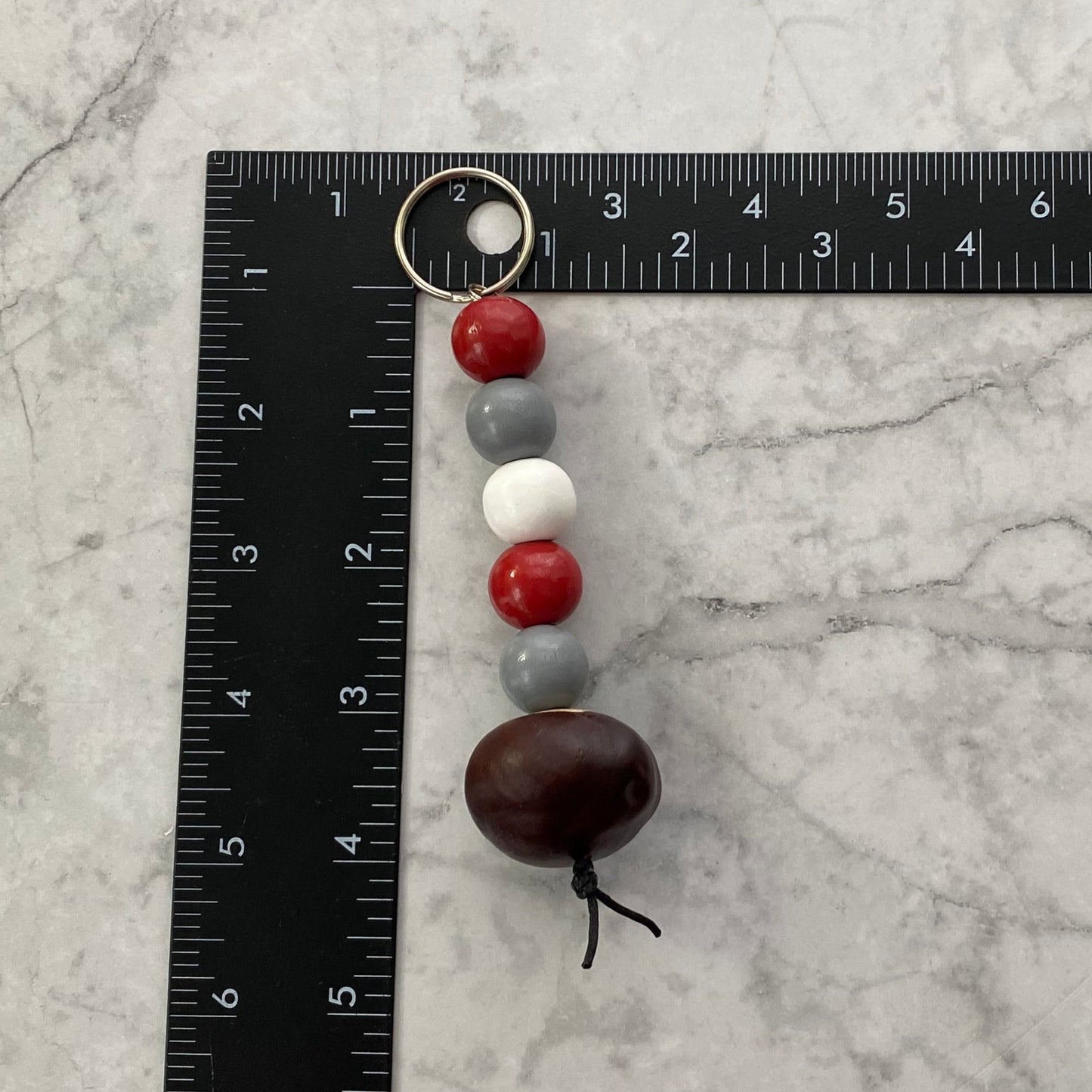 Measurement of Scarlet, Gray and White Wooden Beaded Keychain with Buckeye